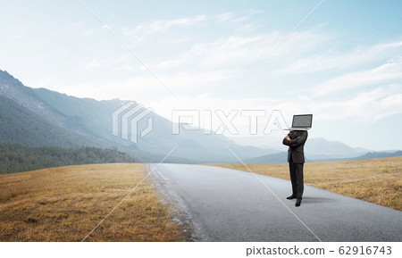 Businessman with laptop instead of head. 62916743