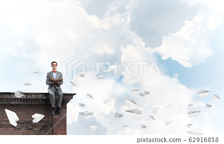 Young businessman or student studying the science 62916858