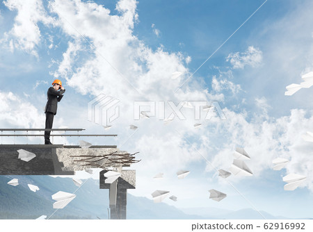 Man in suit looking up for new ideas. 62916992