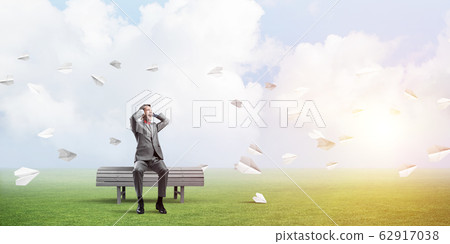 Young man in suit in park dont want to hear anything 62917038