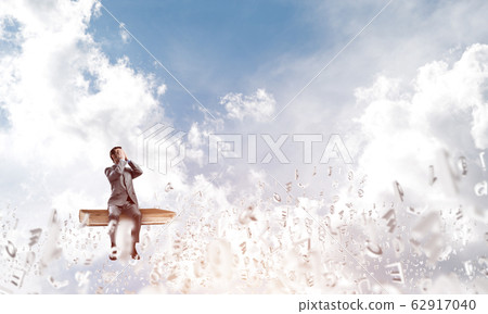 Young man floating in sky and do not want to see anything 62917040