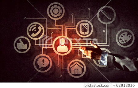 Close of businessman hand showing at user interface glowing on wall Close of businessman hand showing at user interface glowing on wall 62918030