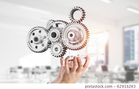 Engine mechanism in male hands as symbol for cooperation or team 62918263