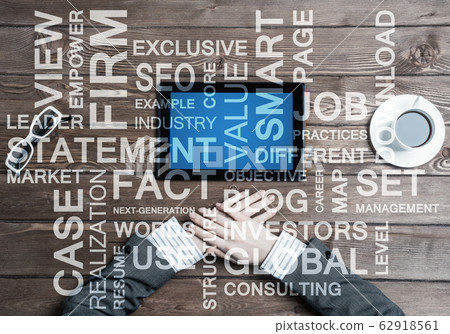 Business workplace with tablet device coffee cup and conceptual words Business workplace with tablet device coffee cup and conceptual words 62918561
