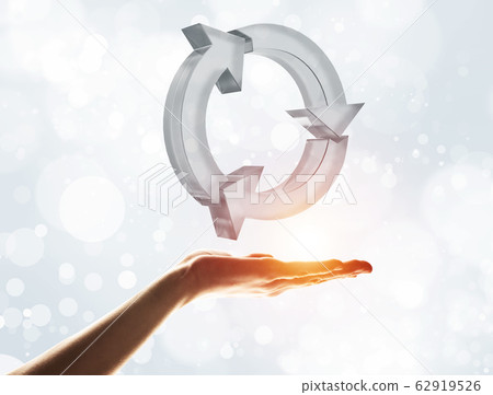 Concept of reuse and recycle presented by glass icon in palm 62919526