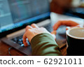 closeup mans hands freelancer sitting in cafe working laptop 62921011