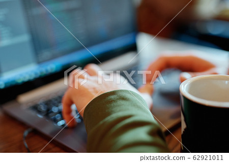 closeup mans hands freelancer sitting in cafe working laptop 62921011