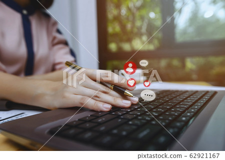 Closeup of businesswoman hands with pen on laptop Closeup of businesswoman hands with pen on laptop 62921167