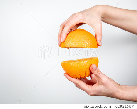 Orange in hand on white background. Vegetarian food and vitamins 62921597