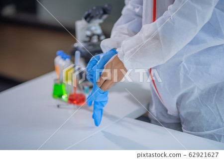 Human holding Variation of Latex Glove, human hand is wearing a medical glove. Human holding Variation of Latex Glove, human hand is wearing a medical glove. 62921627