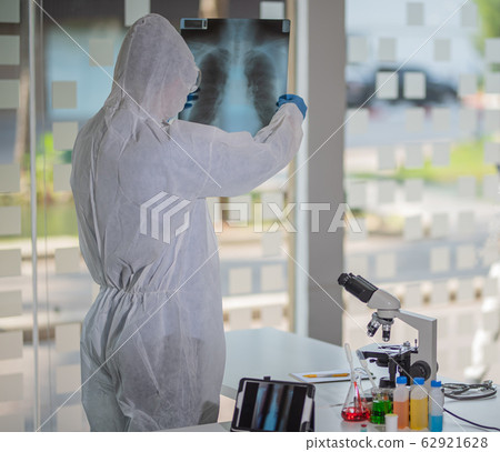 Portrait of a doctor looking at a radiography. Portrait of a doctor looking at a radiography. 62921628