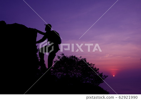 Photographer climbing on the top of the mountain Photographer climbing on the top of the mountain 62921990
