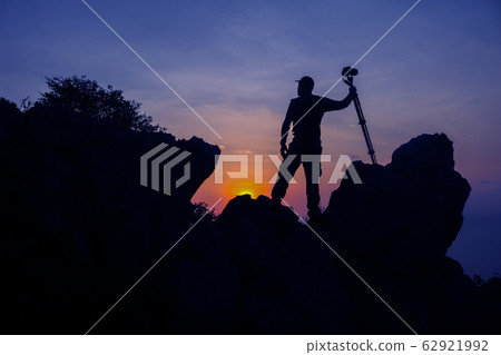 Photographer climbing on the top of the mountain Photographer climbing on the top of the mountain 62921992