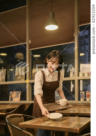 Portrait of young woman and man, part timer and owner 411 62923204