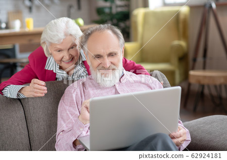 Elderly married couple smiling while having video call 62924181