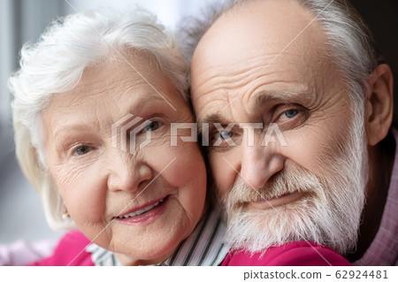 Close up picture of elderly grey-haired smiling couple Close up picture of elderly grey-haired smiling couple 62924481