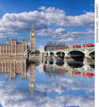 Big Ben and Houses of Parliament with red buses on the bridge in London, England, UK 62924977