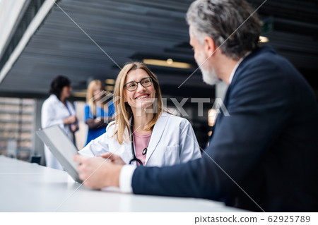 Doctor talking to a pharmaceutical sales representative. Doctor talking to a pharmaceutical sales representative. 62925789