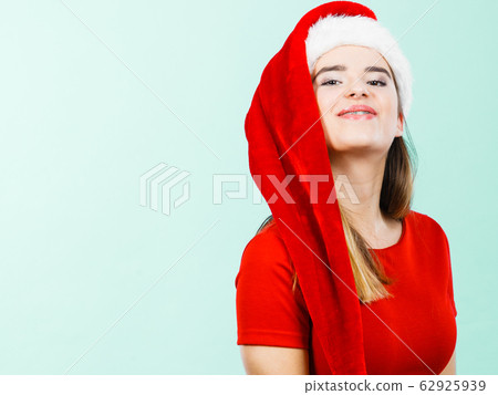 Positive woman wearing Santa Claus helper costume 62925939
