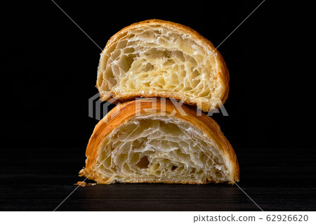Croissant cut in a half on black background 62926620