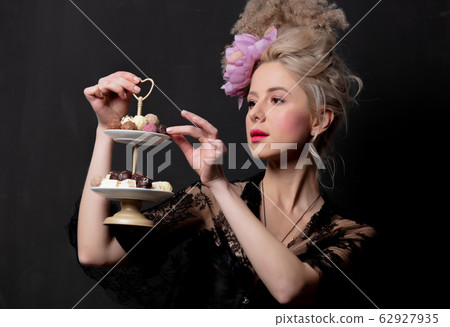 Beautiful blonde countess with chocolate candies Beautiful blonde countess with chocolate candies 62927935