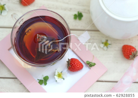 Tea and strawberries in a photo frame 62928855
