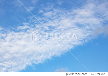 Clouds on the blue sky, blurred background Clouds on the blue sky, blurred background 62929384