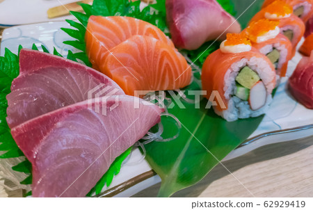Japanese food set. Salmon sushi and sashimi. Japanese food set. Salmon sushi and sashimi. 62929419