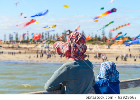 Children watching kites from Semaphore Jetty 62929662