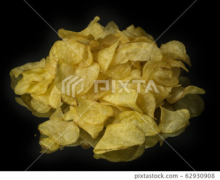 heap of potato chips on a black mirror surface heap of potato chips on a black mirror surface 62930908