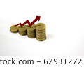 Growing stack of coins with rising red arrow. 62931272