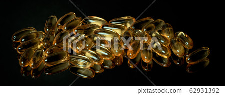 Many fish oil capsules on a black mirror surface 62931392