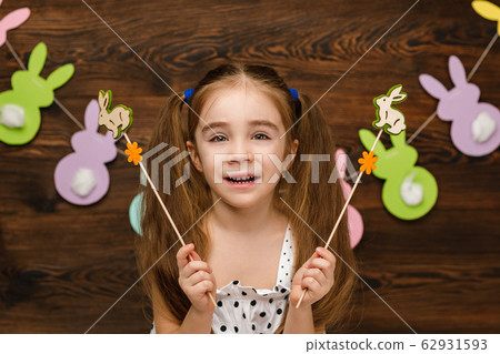 child girl holding a bunny figurine 62931593