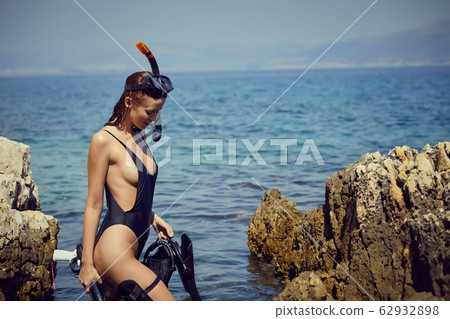 Aqua woman diver spearfishing gun. Hunter concept 62932898