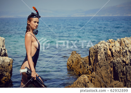 Aqua woman diver spearfishing gun. Hunter concept 62932899