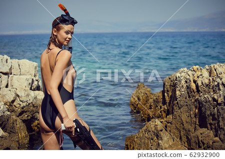 Aqua woman diver spearfishing gun. Hunter concept 62932900