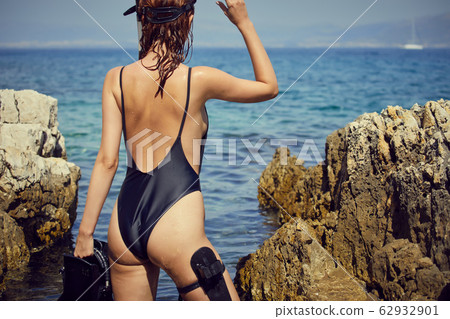 Aqua woman diver spearfishing gun. Hunter concept 62932901