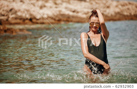 Bikini girl on the beach. Young beautiful woman in 62932903