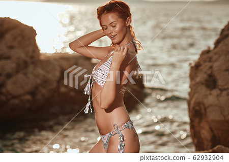 Bikini girl on the beach. Young beautiful woman in Bikini girl on the beach. Young beautiful woman in 62932904