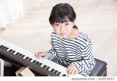 Girls practicing piano 62933057