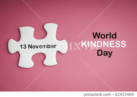 WORLD KINDNESS DAY text with white jigsaw puzzle WORLD KINDNESS DAY text with white jigsaw puzzle 62933409
