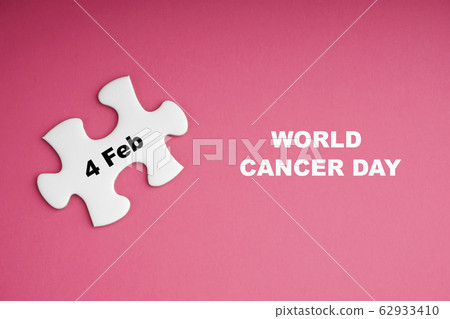 WORLD CANCER DAY text with white jigsaw puzzle on 62933410