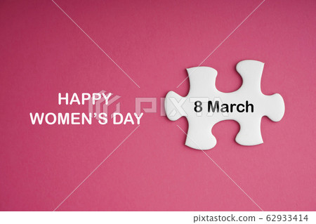 HAPPY WOMEN DAY text with white jigsaw puzzle on 62933414