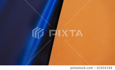 Blue fabric on painted wall background Blue fabric on painted wall background 62934198