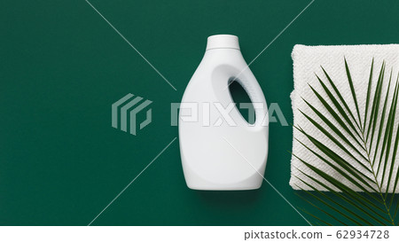 White bottle with bio washing conditioner on green 62934728