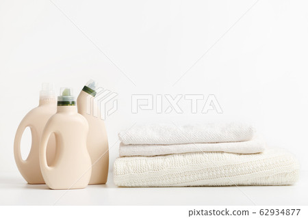 Pile of folded clean towels with bio bottles packaging Pile of folded clean towels with bio bottles packaging 62934877