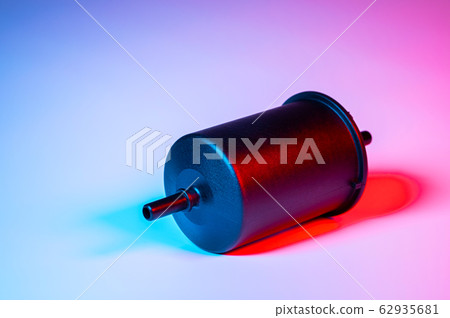 New fuel filter in a black plastic housing for diesel and gasoline engines in double red-blue light New fuel filter in a black plastic housing for diesel and gasoline engines in double red-blue light 62935681