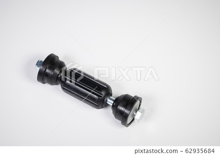 Car front suspension anti-roll bar mount. New tie rod on gray background 62935684
