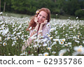 Beautiful woman enjoying field, harmony concept 62935786