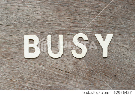 Alphabet letter in word busy on wood background 62936437